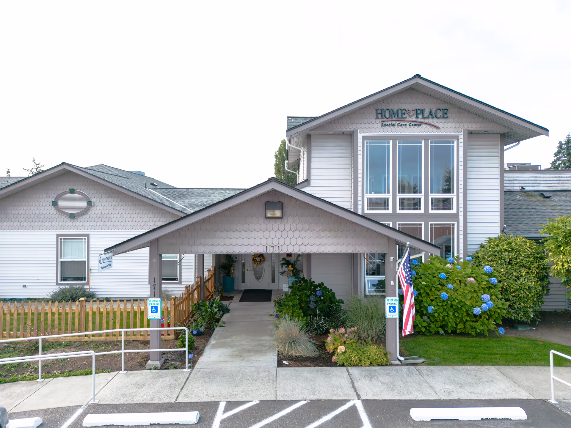 Front view of HomePlace Special Care at Oak Harbor with a covered entrance and landscaping.