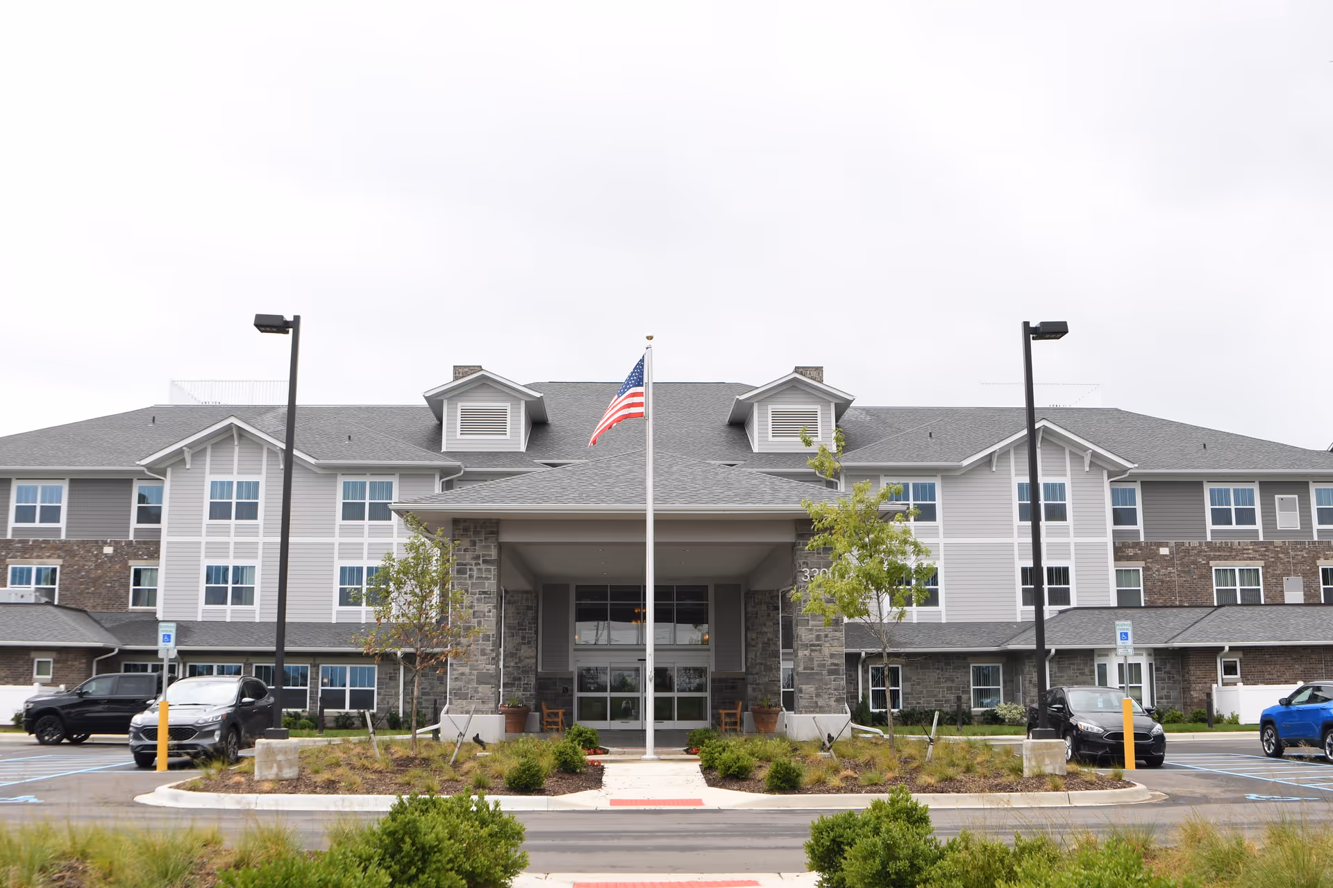 Rolling Hills Retirement Community exterior with central entrance, flagpole, and parking.