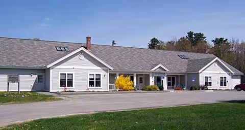 Penobscot Terrace exterior: a single-story building with windows, shrubs, and a parking lot.