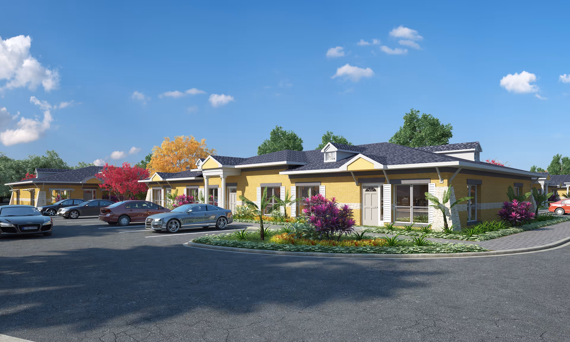 Single-story yellow senior living building with landscaped beds and cars parked in front under a blue sky.