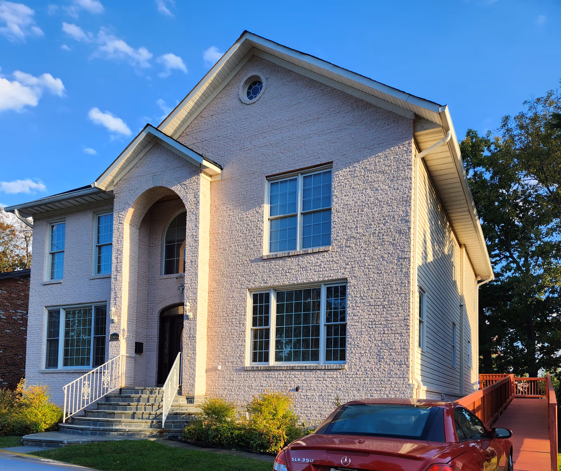 Care Personnel Healthcare facility: two-story light brick building with arched entry and ramp.