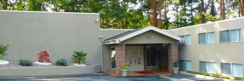 Front view of Hill House RCF entrance with covered doorway and landscaping.
