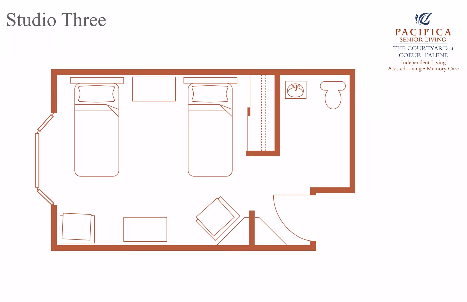 Floor plan labeled Studio Three showing a layout with two beds, a small table between them, a chair, a small table, a closet, and a bathroom with a sink and toilet.