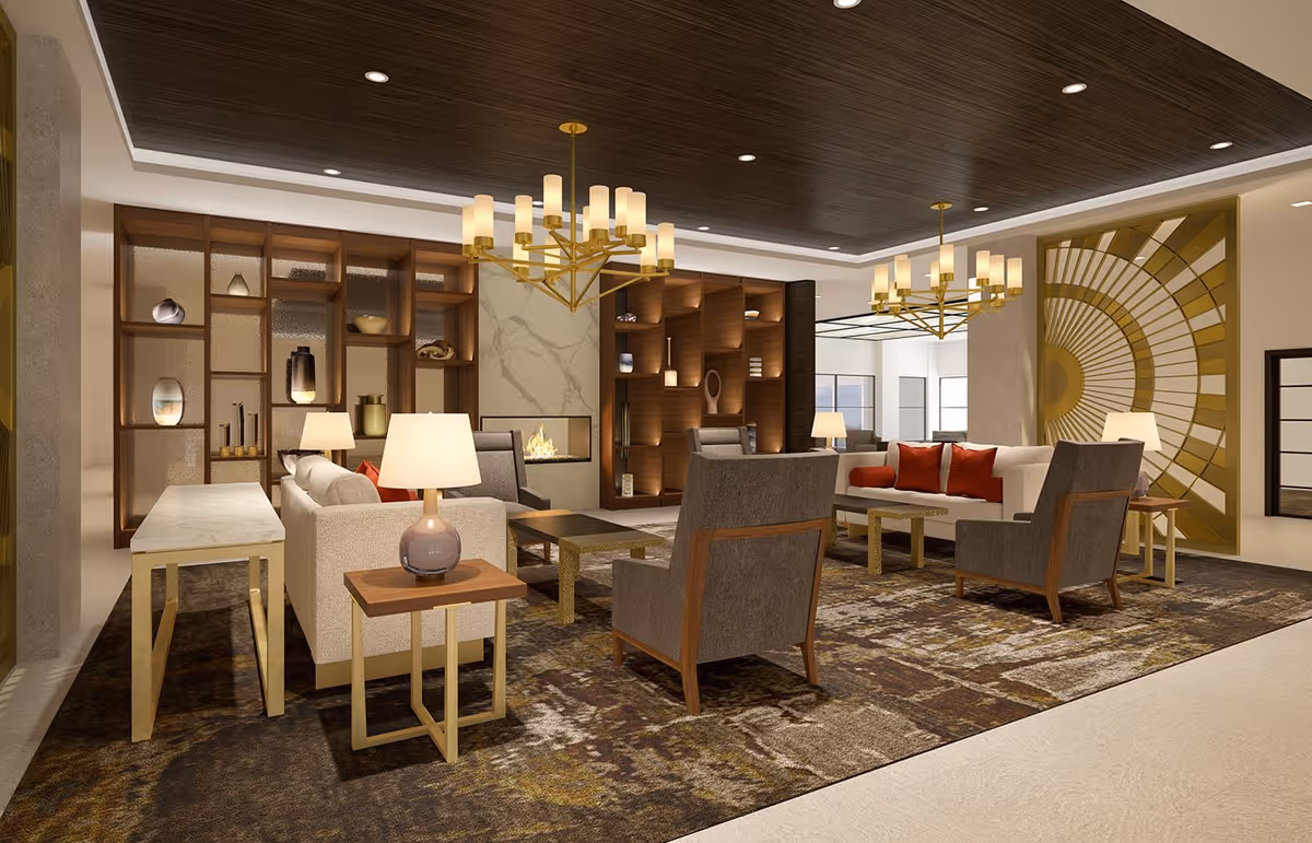 A spacious and elegant living room area with modern furniture including sofas, armchairs, and side tables with lamps. The room features a large decorative rug, two gold chandeliers, a built-in fireplace with a marble surround, and wooden shelving units with decorative items. The ceiling has dark wood paneling with recessed lighting, and a large gold geometric wall art piece is visible on the right side.