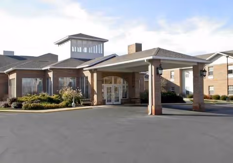 The Waterford at Mansfield exterior entrance with porte-cochere and brick facade.
