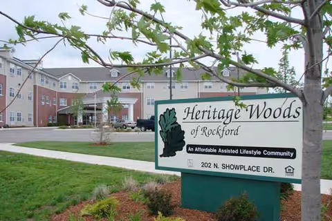 Exterior view of Heritage Woods of Rockford with sign and landscaped lawn