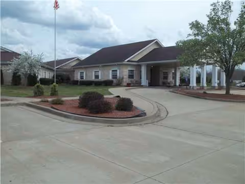 The senior living center's entrance shows a driveway, landscaping, and flagpole.