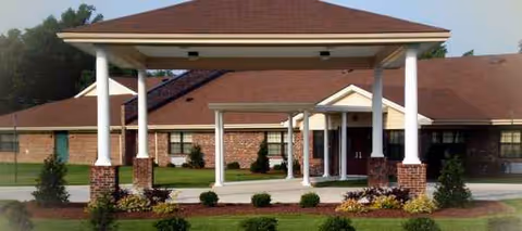 Front entrance of Edenton Primetime Retirement Center with brick facade and covered drop-off.