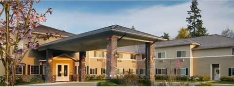 The front exterior view of Olympic View Assisted Living features a covered entrance.