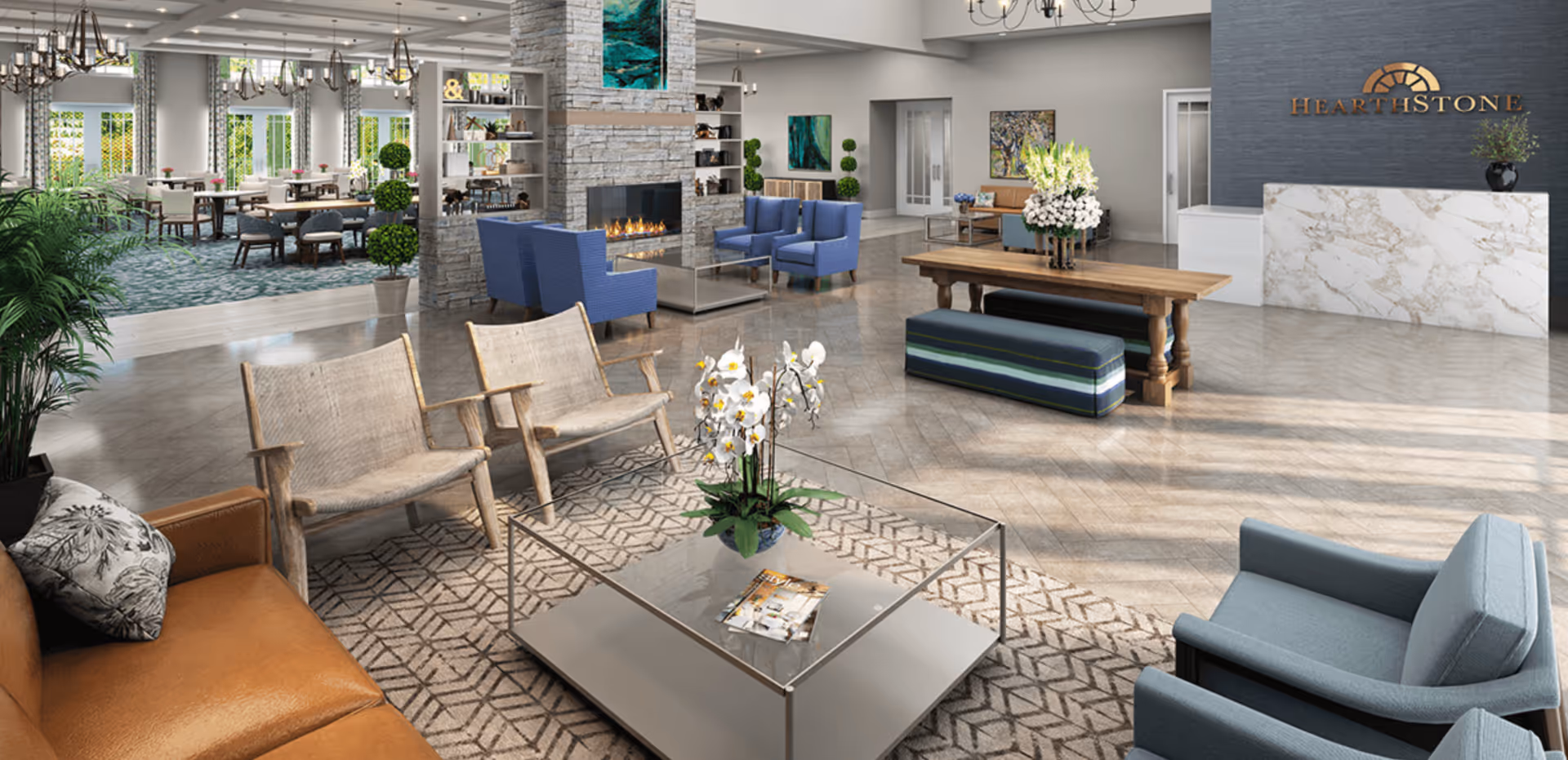 A spacious and well-lit senior living facility common area with a modern fireplace surrounded by blue armchairs, a glass coffee table with a flower arrangement, wooden chairs, and a brown leather sofa. In the background, there is a dining area with tables and chairs, large windows with curtains, and a reception desk with the HearthStone logo on the wall behind it.