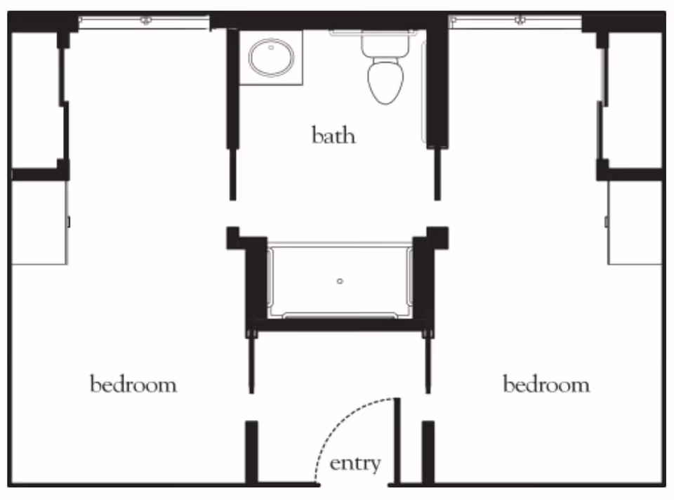 Floor plan layout showing two bedrooms on either side of a central bathroom. The bathroom includes a sink, toilet, and bathtub. There is an entry door at the bottom center of the plan.