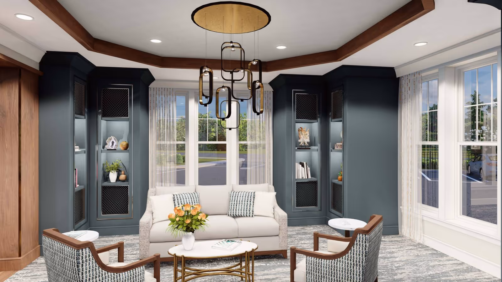 Furnished living room with a sofa, two armchairs, coffee table, built-in shelving and large windows.