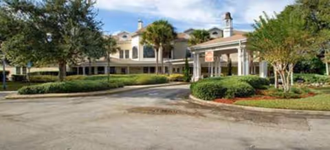 Front view of Colliers Assisted Living at Port Orange with driveway and entrance canopy.