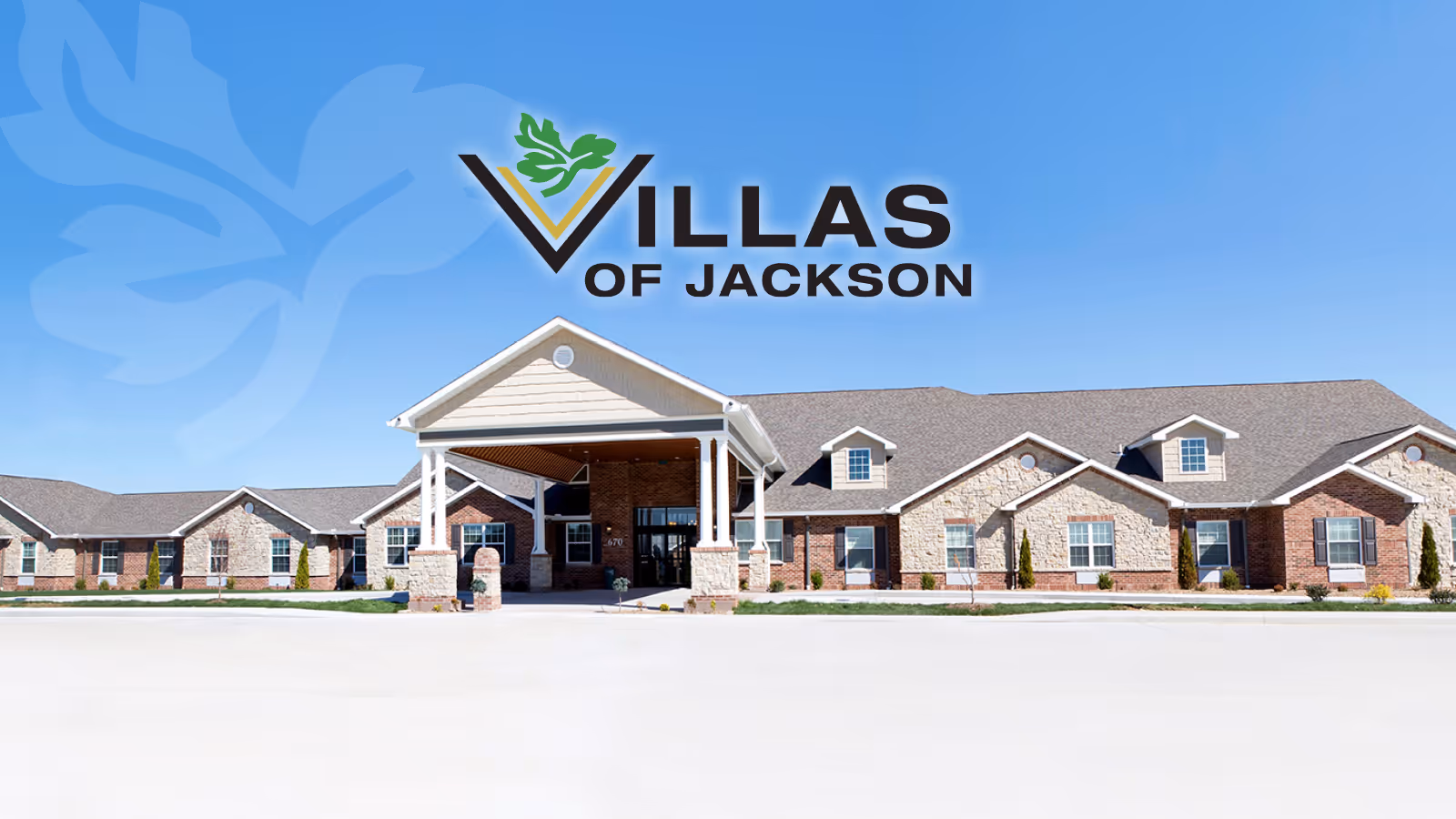 Front exterior view of The Villas of Jackson building under a clear blue sky.
