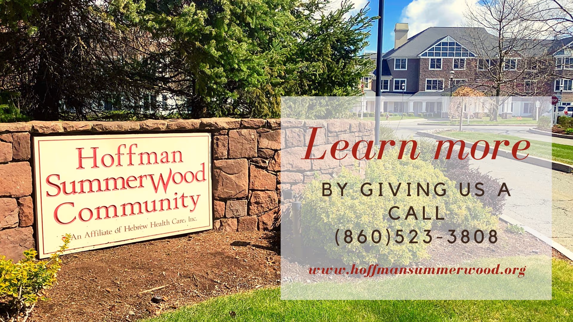 Outdoor view of the entrance sign for Hoffman SummerWood Community, a senior living facility, with a stone wall and greenery. In the background, there is a large building with multiple windows and a driveway. Text overlay invites viewers to learn more by calling a phone number and visiting the website.