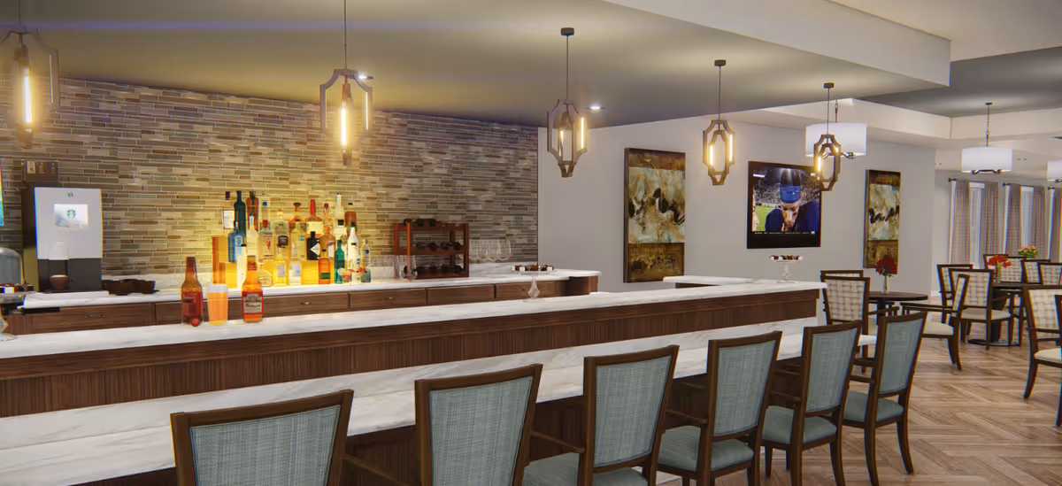 A modern communal bar and dining area with a long marble-topped counter, bar stools, pendant lights, and dining tables.