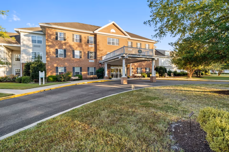 Exterior view of Lakeside At Mallard Landing senior living facility with landscaped grounds.