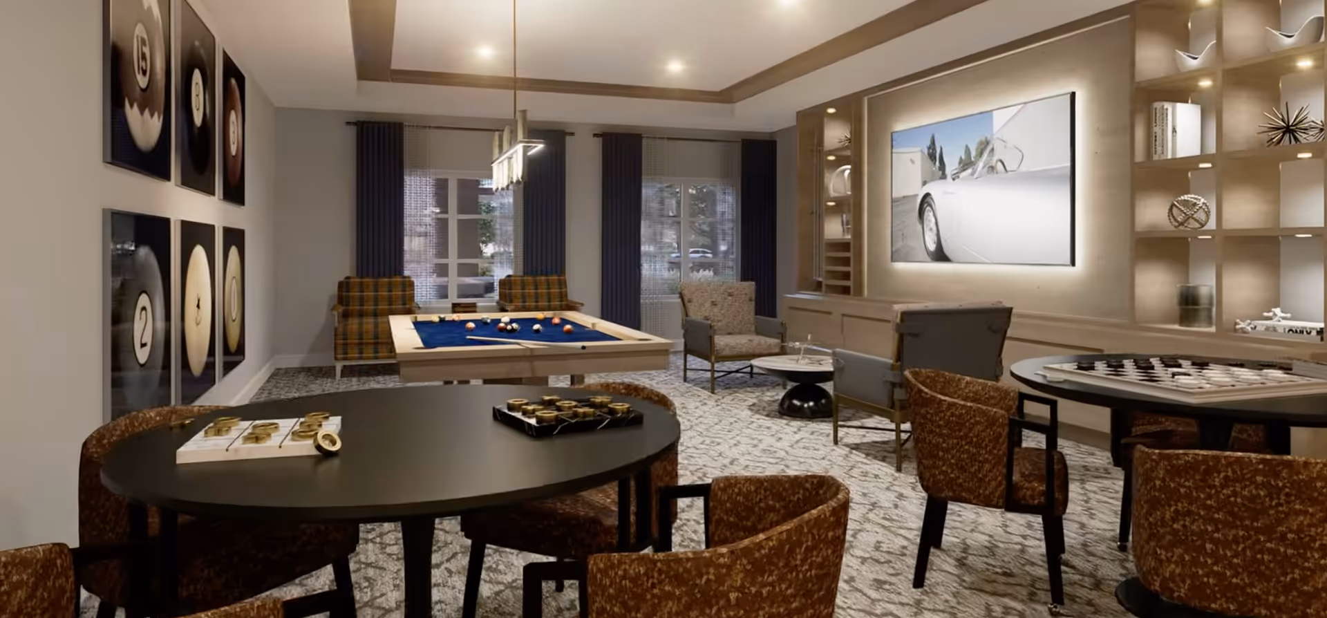 A stylish game room featuring a pool table with balls arranged on it, several round tables with chairs, and a large TV mounted on the wall. The room has decorative shelving with various ornaments, a patterned carpet, and framed pictures of billiard balls on one wall. Large windows with dark curtains allow natural light into the space.