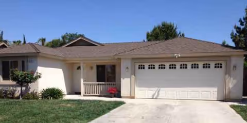 Front exterior of Ideal Home senior living facility with a two-car garage.