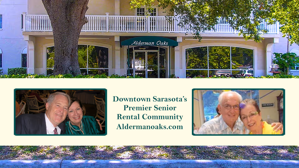 Front entrance of Alderman Oaks retirement residence with a promotional banner reading "Downtown Sarasota's Premier Senior Rental Community" and photos of smiling seniors.