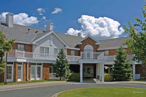 Exterior view of Woodbury Health Care Center with brick facade and landscaping.