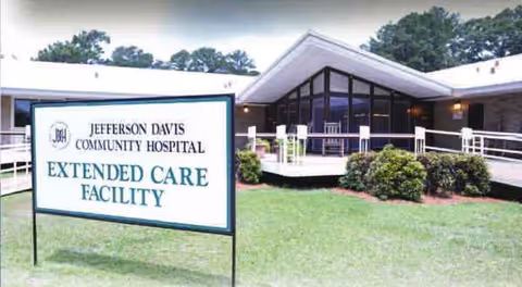 Front exterior of Jefferson Davis Community Hospital Extended Care Facility with landscaping.