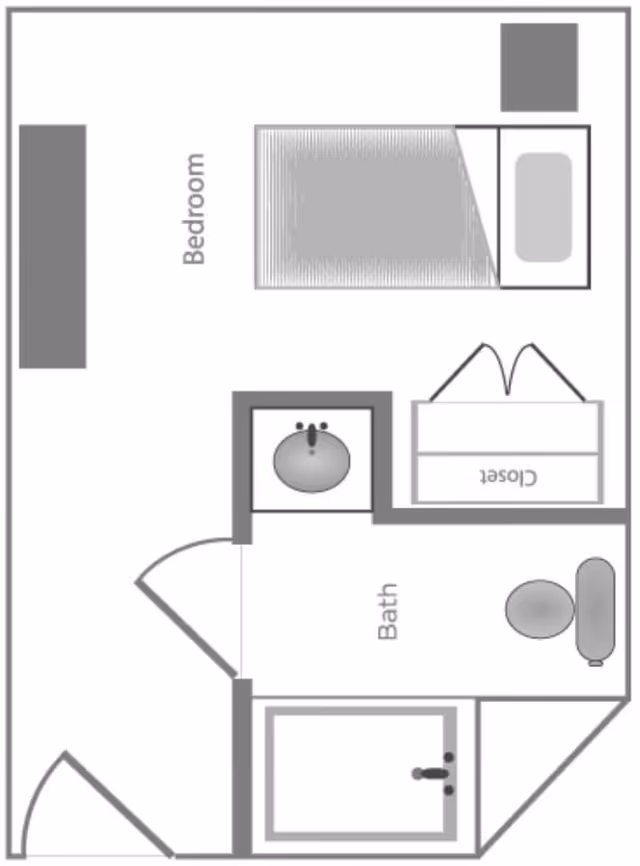 Floor plan layout of a small assisted living unit showing a bedroom with a bed and closet, and an adjacent bathroom with a sink, toilet, and shower.
