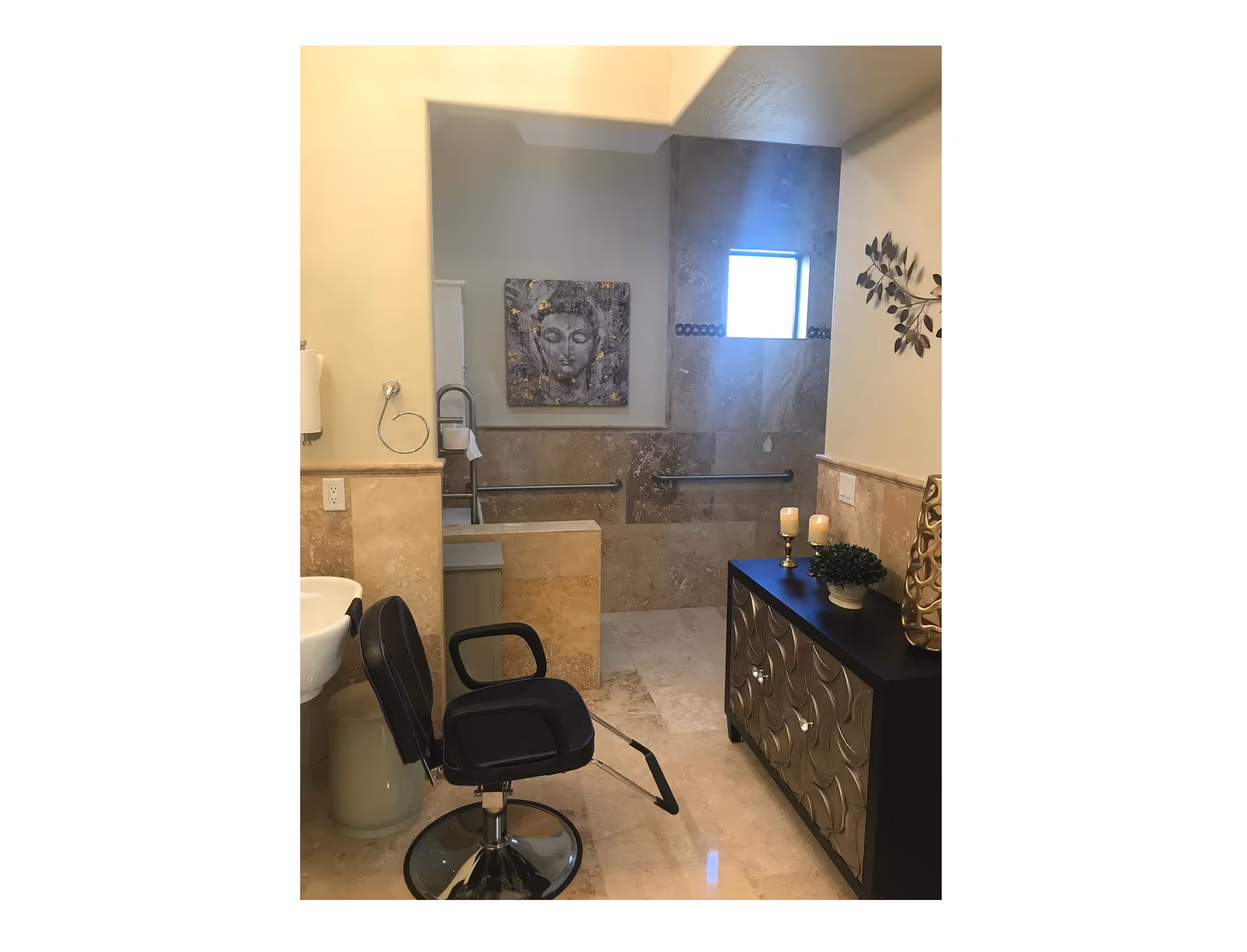 Accessible bathroom featuring a salon-style chair and sink, decorative cabinet, and a walk-in tiled shower with a Buddha artwork on the wall.