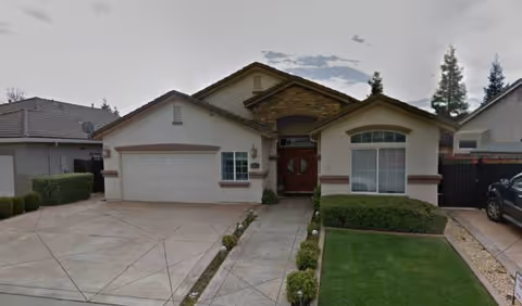 Front exterior of Bright Homes LLC facility, a single-story house with driveway and lawn.