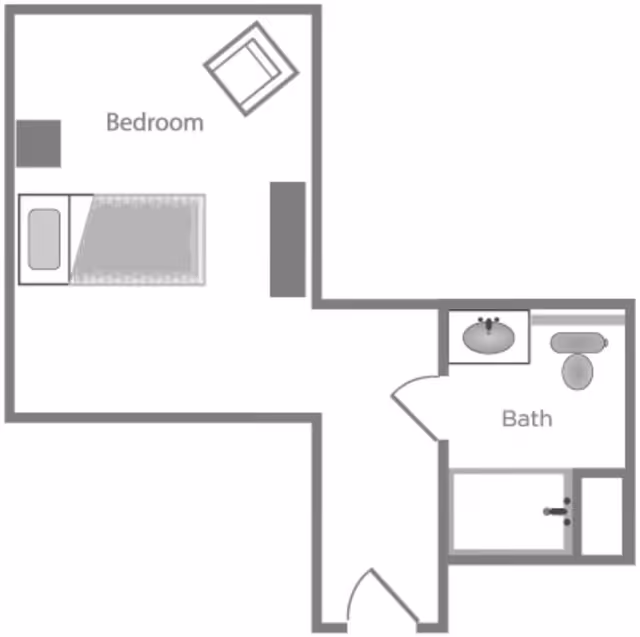 Floor plan of a small assisted living unit at Woodland Ridge Assisted Living, showing a bedroom with a bed, chair, and dresser, connected to a bathroom with a sink, toilet, and bathtub.