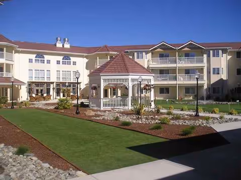 Exterior view of Countryside Village senior living courtyard featuring a gazebo, paths, and landscaping.