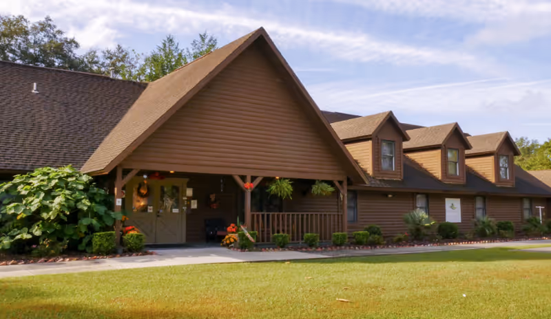 Brown wooden Homewood Lodge ALF exterior with a gabled roof and front porch.