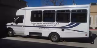 White shuttle bus with purple graphics parked in a lot outside Garland Nursing and Rehabilitation Center.