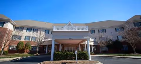 Front view of Brookdale South Charlotte senior living building with covered entrance.