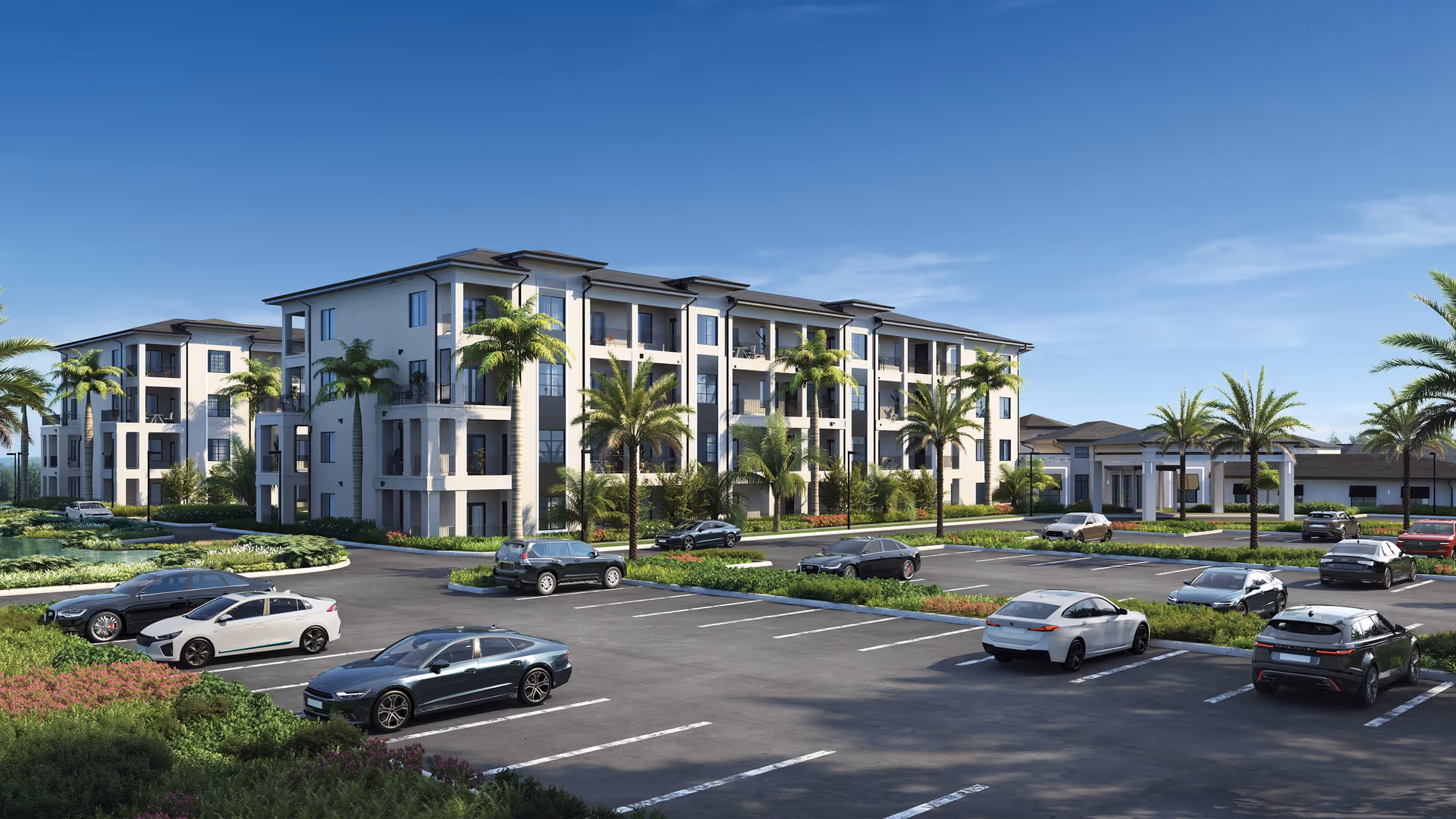 Front exterior of a modern three-story senior living complex with palm trees and a parking lot with cars under a clear blue sky.