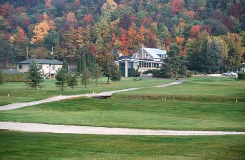 Exterior view of Oasis Palms Inc. campus with manicured lawn, trees, and autumn colors.