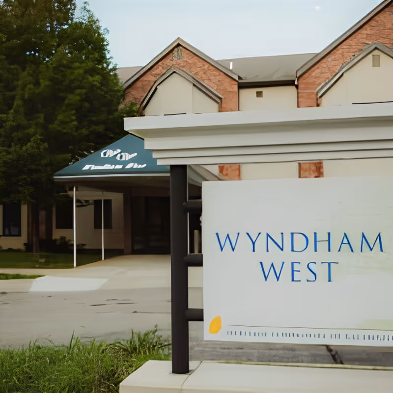 Front entrance and sign for the Wyndham West facility showing the canopy and building facade.