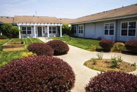 Exterior view of Walker Place with walkway and circular landscaped plant beds.