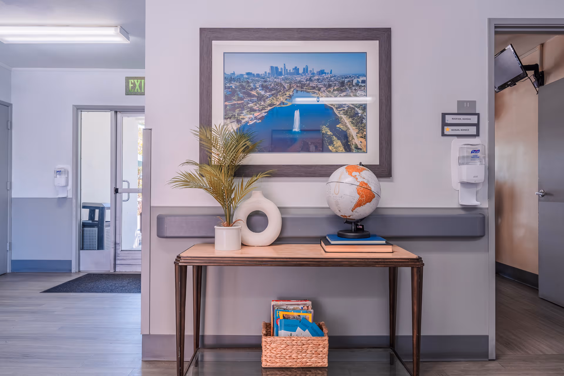 A welcoming entrance area featuring a globe, plant, and framed artwork.