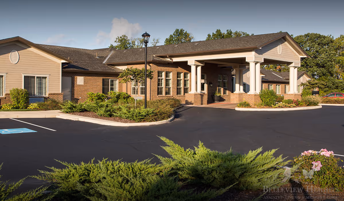 Exterior view of Belleview Heights entrance with a parking lot and landscaping.