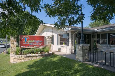 Exterior view of Wellington Rehabilitation and Healthcare with sign and entrance.