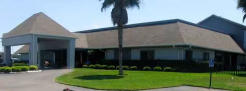 Front exterior view of Oakview Terrace Assisted Living building with driveway and landscaping