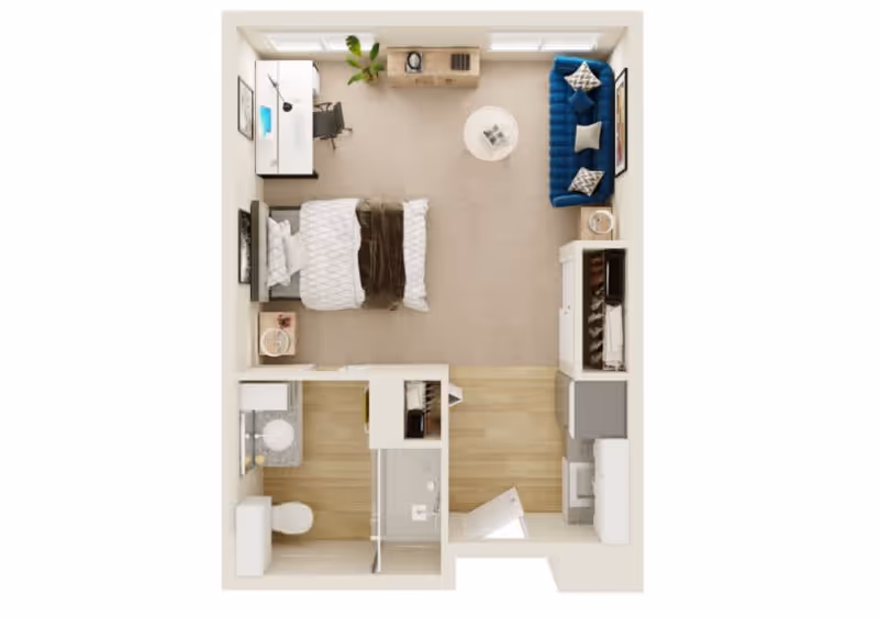 Top-down view of a studio apartment floor plan featuring a combined living and sleeping area with a bed, blue couch, round coffee table, desk with chair, and dresser. The apartment also includes a small kitchen area with appliances and cabinetry, and a bathroom with a toilet, sink, and shower.