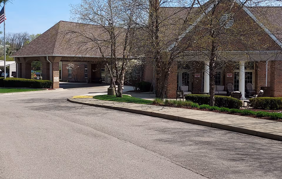 Exterior view of Autumn House Bloomfield Hills, a brick senior living facility with a front entrance.