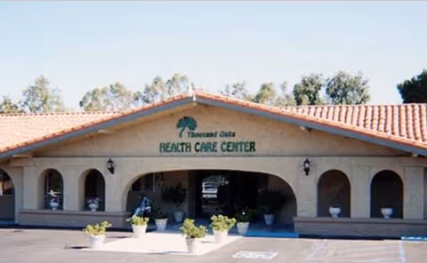 Thousand Oaks Health Care Center front entrance with arches and potted plants.