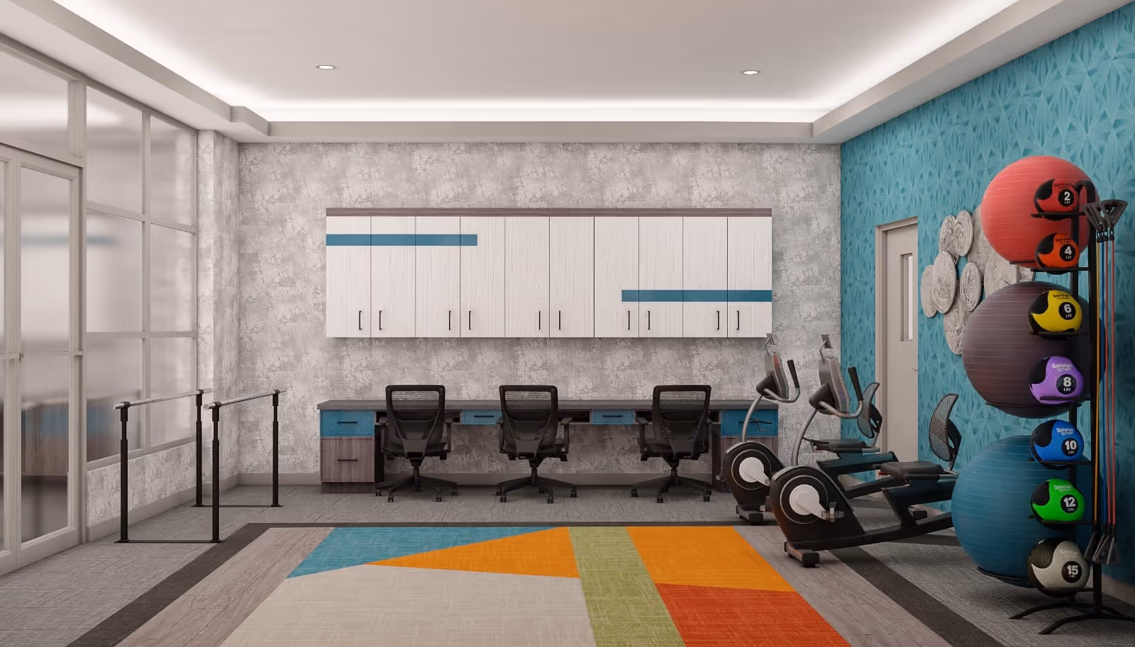 Exercise/therapy room with cardio machines, a rack of colorful medicine balls, parallel bars, and a desk workspace against a textured wall.