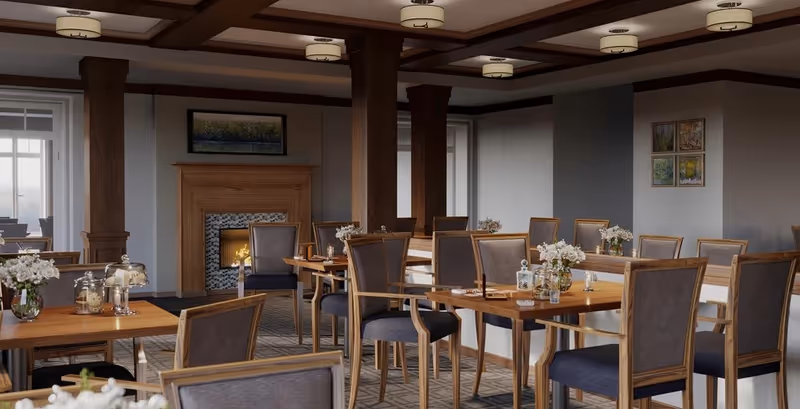 A dining room with wooden tables and chairs, floral centerpieces, and a fireplace in the background.