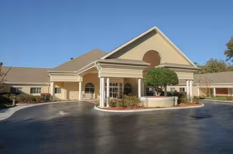 Exterior view of Life Care Center of Citrus County entrance with circular driveway and landscaping.
