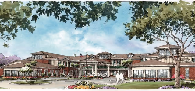 Illustration of the front exterior view of a large senior living facility building with multiple roof levels, a covered entrance, landscaped grounds, and several flags flying near the entrance.
