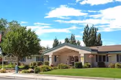 Exterior of Evergreen Nursing Home with covered entrance and manicured lawn